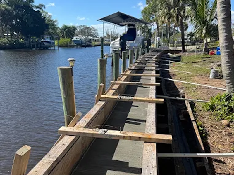 Stabilized seawall behind a Port St. Lucie canal home after void filling and joint sealing